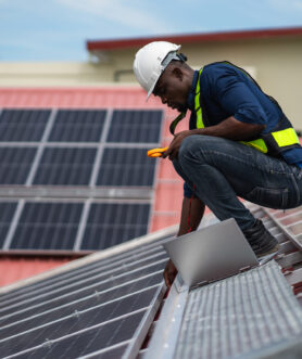 Service engineer checking solar cell on the roof for maintenance if there is a damaged part. Engineer worker install solar panel. Clean energy concept.